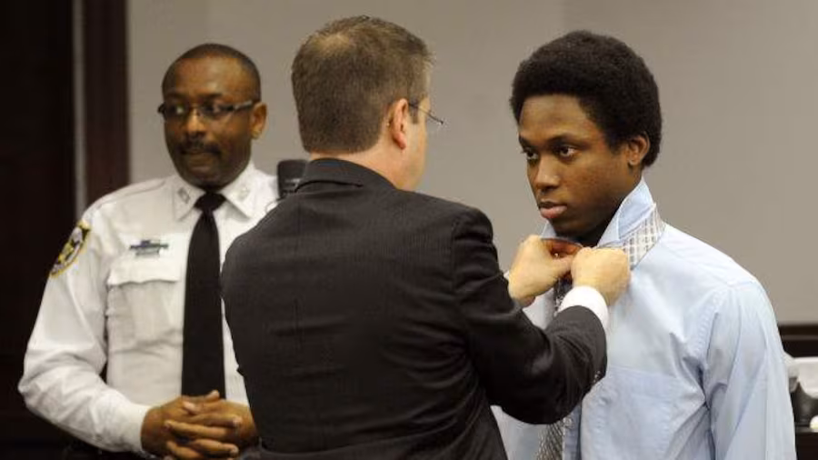 Rocky Brancato fastens Richard McTear's tie in preparation for court.