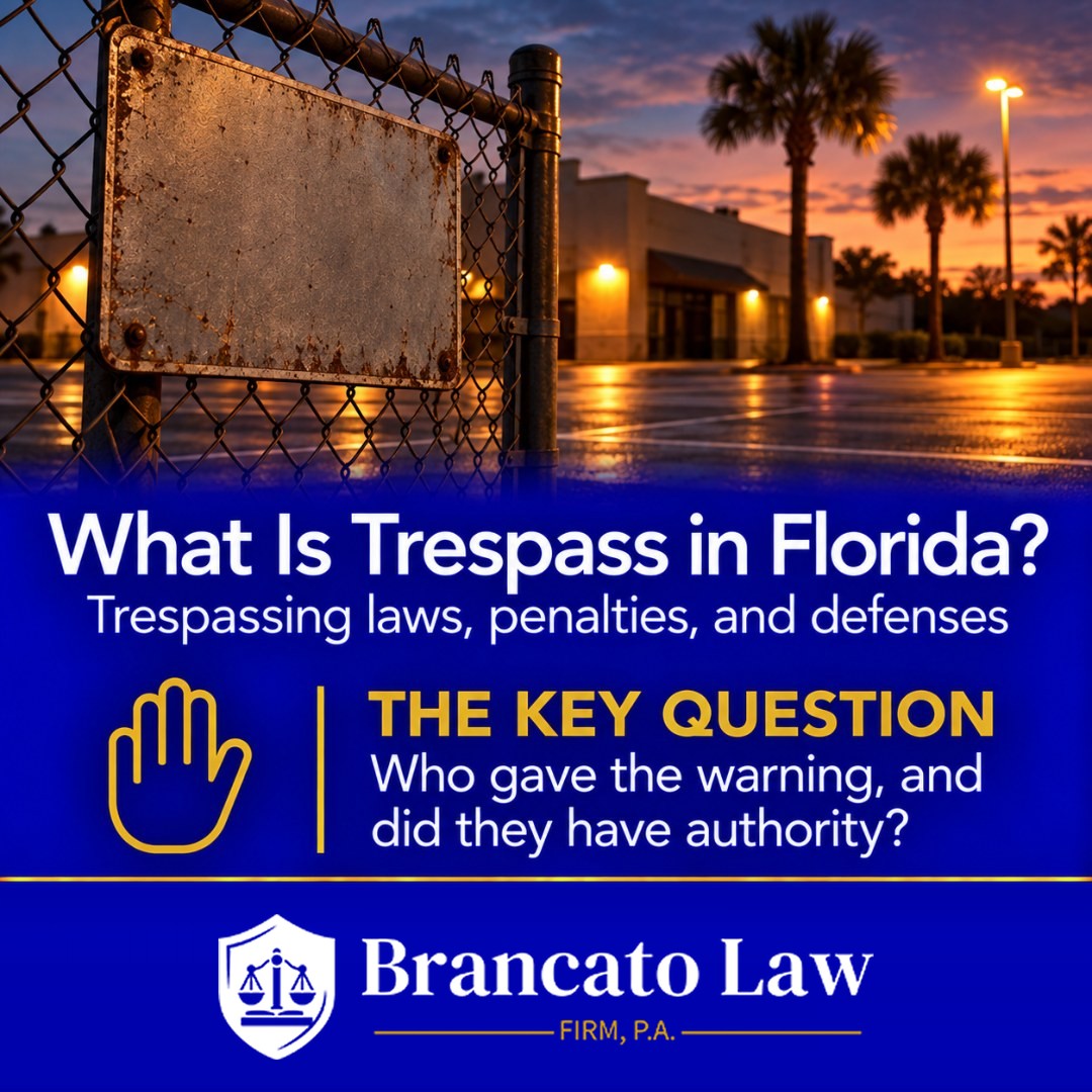 Cover graphic for The Brancato Law Firm, P.A. guide to Florida trespassing laws by Tampa criminal defense attorney Rocky Brancato. A blank sign on a chain-link fence at a closed Florida business at dusk, with the headline What Is Trespass in Florida? and the key question in every trespass case: who gave the warning, and did that person have authority.